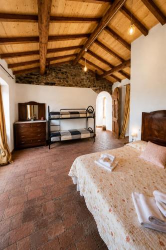 a bedroom with two beds and a wooden ceiling at Antica Calvasino in Lezzeno