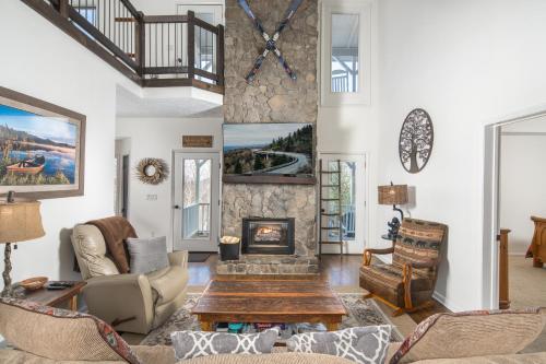 a living room with a table and a fireplace at Flat Top Lodge in Blowing Rock