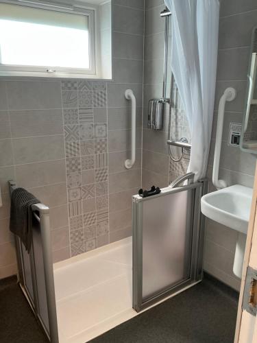 a bathroom with a shower and a sink at Chamberlain House in Derry Londonderry