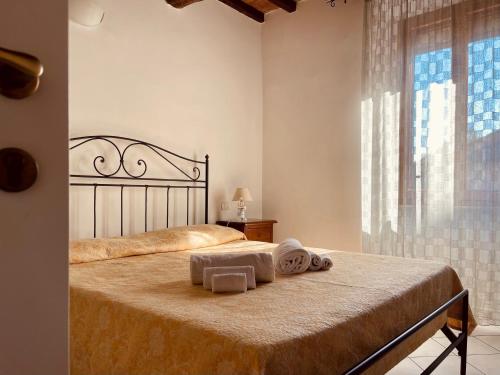 a bedroom with a bed with two towels on it at Affittacamere La Mattonata in Città di Castello