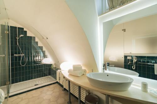 a bathroom with a sink and a shower and a tub at La Casa di Nadì in Matera