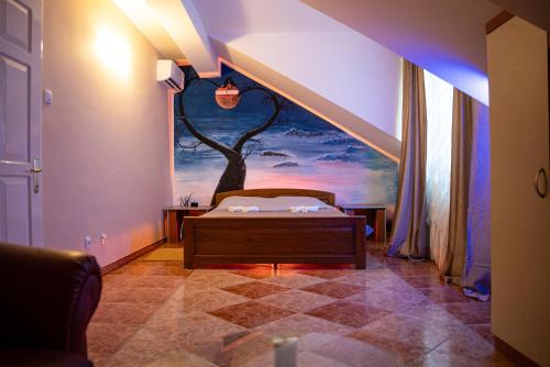 a bedroom with a tree mural on the wall at Rooms Asceric in Stari Banovci