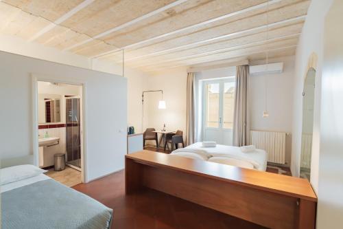 a bedroom with a bed and a desk in a room at La Casa di Nadì in Matera