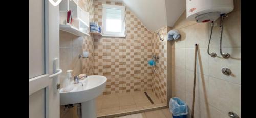 a bathroom with a sink and a shower at Vila-kuca"Jasmin"pored rijeke i jezera in Konjic