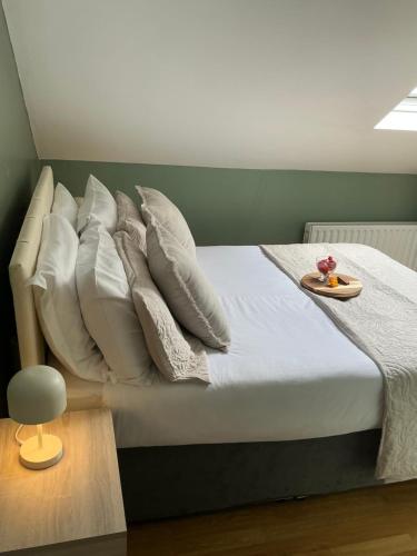 a bed with pillows and a tray on top of it at Chamberlain House in Derry Londonderry