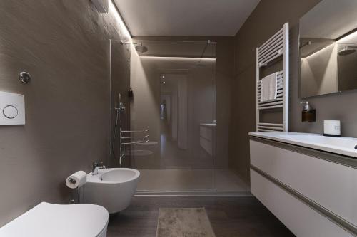 a bathroom with a sink and a toilet and a shower at Angels Home 3-AffittiPontediLegno in Ponte di Legno