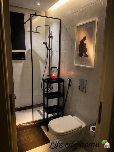 a bathroom with a shower and a toilet at Life city home in 6th Of October