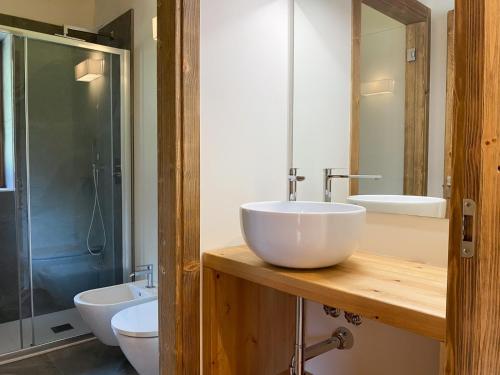 a bathroom with a white sink and a shower at Chalet la Mia Baita - AffittiPontediLegno in Pezzo