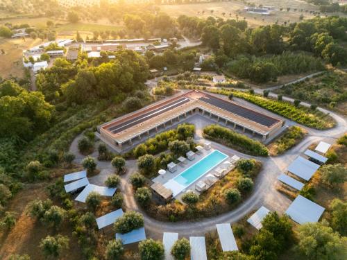 an aerial view of a building with a swimming pool at Gandum Village - Conscious Boutique Hotel in Montemor-o-Novo