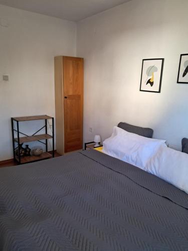 a bedroom with a large bed and a wooden door at TILIA Apartmet in Struga