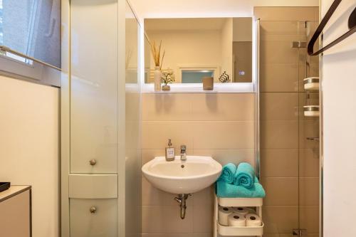 a bathroom with a sink and a shower at Lakeside Retreat Apartment in Bestensee