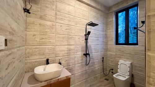a bathroom with a sink and a shower and a toilet at The Yoyo's Stay in Arusha