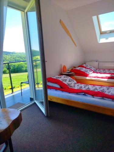 a bedroom with a bed and a sliding glass door at Gorczańska EKO-SFERA in Wola Piskulina