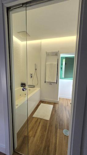 a bathroom with a shower and a bath tub at Casa rural Villa Quintans in Soutullo