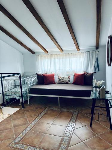 a couch in a room with a window at Casa Avoa María in Ourense