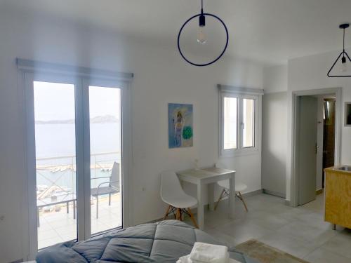 a bedroom with a bed and a view of the ocean at 12 Gods Resort in Pylos