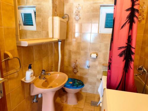 a bathroom with a sink and a toilet at Apartment Josip in Primošten