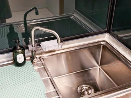 a kitchen sink with a bottle of soap next to it at ความเจริญที่เงียบสงบ in Bangkok