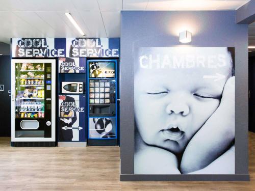 a sign in a store with a picture of a baby at Ibis Budget Marmande in Marmande