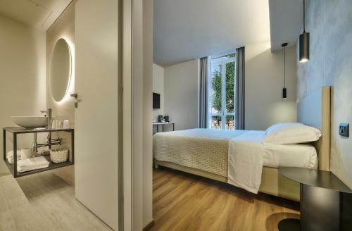 a bedroom with a bed and a window and a table at Monolocale 1 - via Sassi, Lecco in Lecco