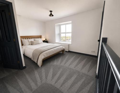 a bedroom with a bed and a window at Self contained property in Cartworth