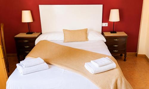 a bedroom with two beds with towels on them at Casa Ilera II, en el corazon de Rioja Alta 8 PAX in Casalarreina