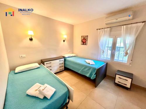 a bedroom with two beds and a window at Villa Marina - Inalko in Alcossebre