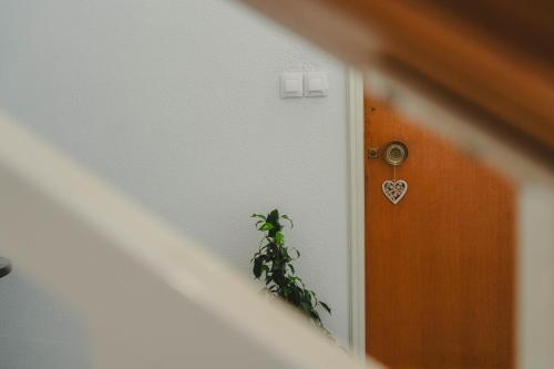 a door with a heart sign on it and a plant at The Beach House in Karistos