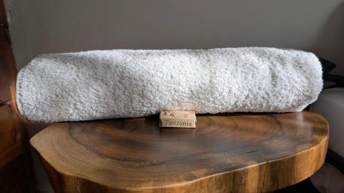 a blanket on top of a wooden table at Nomads nest safari house in Arusha