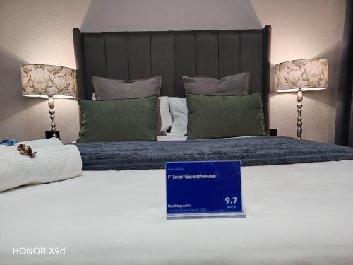 a hotel room with a bed with a blue sign on it at F'leur Guesthouse in Mokopane