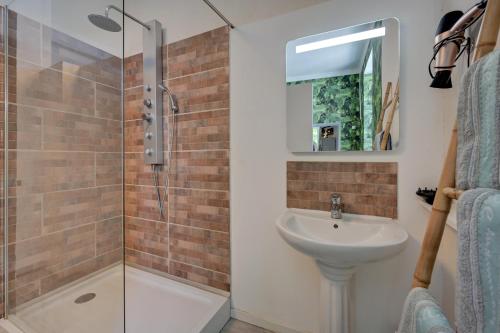 a bathroom with a sink and a shower at lemasrocamour in Roquemaure