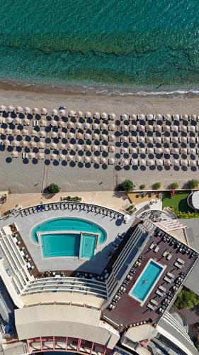 an aerial view of a hotel with pools and the ocean at Konstantinos Palace in Karpathos
