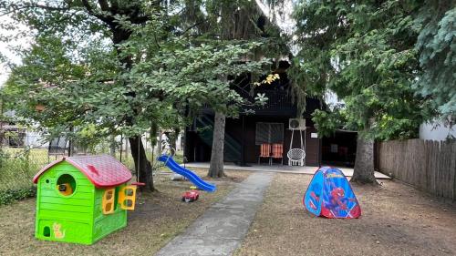 a playground with childrens play equipment in front of a house at DunaLiget Vendégház in Szentendre