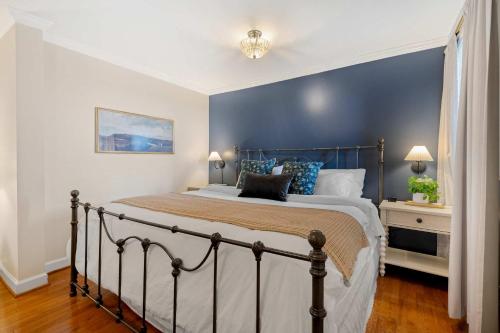 a bedroom with a bed with a blue accent wall at Historic Riverview Inn Suite Nine in Chattanooga