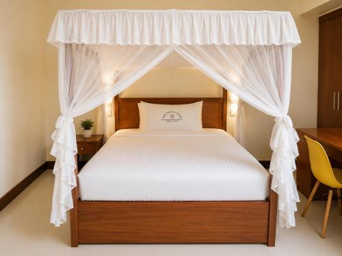 a bedroom with a bed with a canopy at New Swanga in Nairobi
