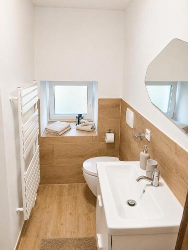 a bathroom with a toilet and a sink at MeinZuhause Apartmente NG in Bad Pyrmont