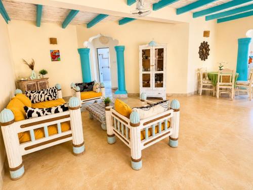 a living room with three couches and a table at Tropical Court 2 BedroomDiani Beach villa in Kwale