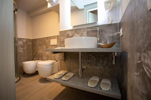 a bathroom with a sink and a toilet at AL 54 Accommodation - Premium in San Benedetto del Tronto