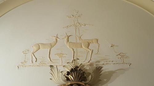 a drawing of deer on a wall at Garden Suite in Genova