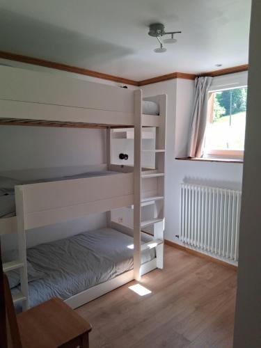 a small room with bunk beds and a window at L'Entre Monts in Saint-Pierre-dʼEntremont
