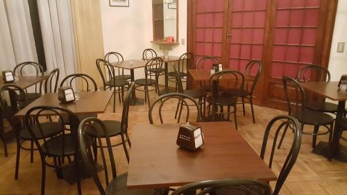 a room full of tables and chairs with cell phones on them at Garden Suite in Genova