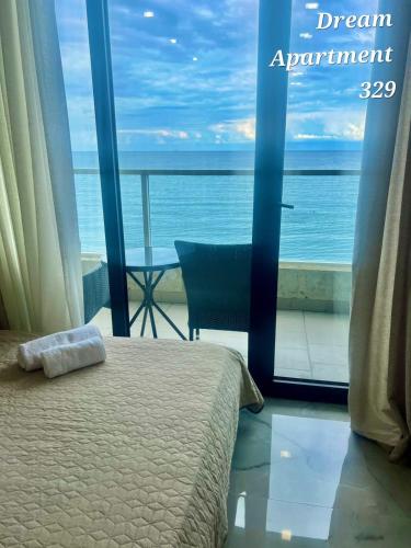 a bedroom with a bed and a view of the ocean at Bamboo beach in Ts'ikhisdziri