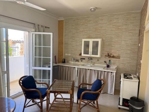 a kitchen with a table and chairs and a sink at Tarbouche House Dahab in Dahab