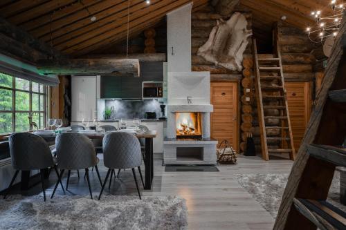 a kitchen with a fireplace in a log cabin at Villa RukanKelo in Ruka
