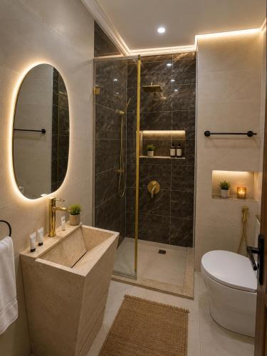 a bathroom with a shower and a sink and a toilet at Leeda Pyramids View in Cairo