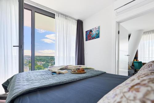 a bedroom with a bed with a large window at WAVE Seaview in Międzyzdroje