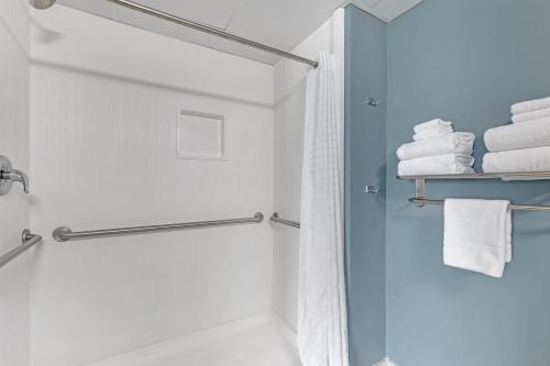 a bathroom with a shower and white towels at Best Western Plus Ocean City in Ocean City