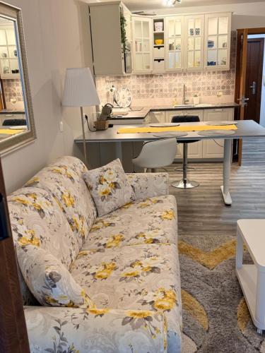 a living room with a couch and a kitchen at Balchik Sea View Studio in Balchik