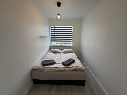 a small bedroom with a bed and a window at Vesturgata 8 KEF in Keflavík