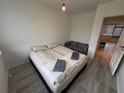 a bedroom with a large bed and a couch at Vesturgata 8 KEF in Keflavík
